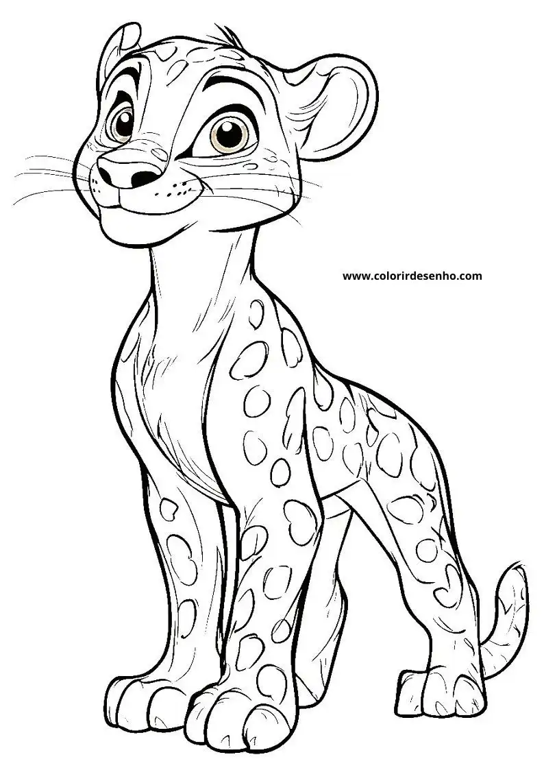 jaguar cub standing alertly in grass with spotted fur looking around