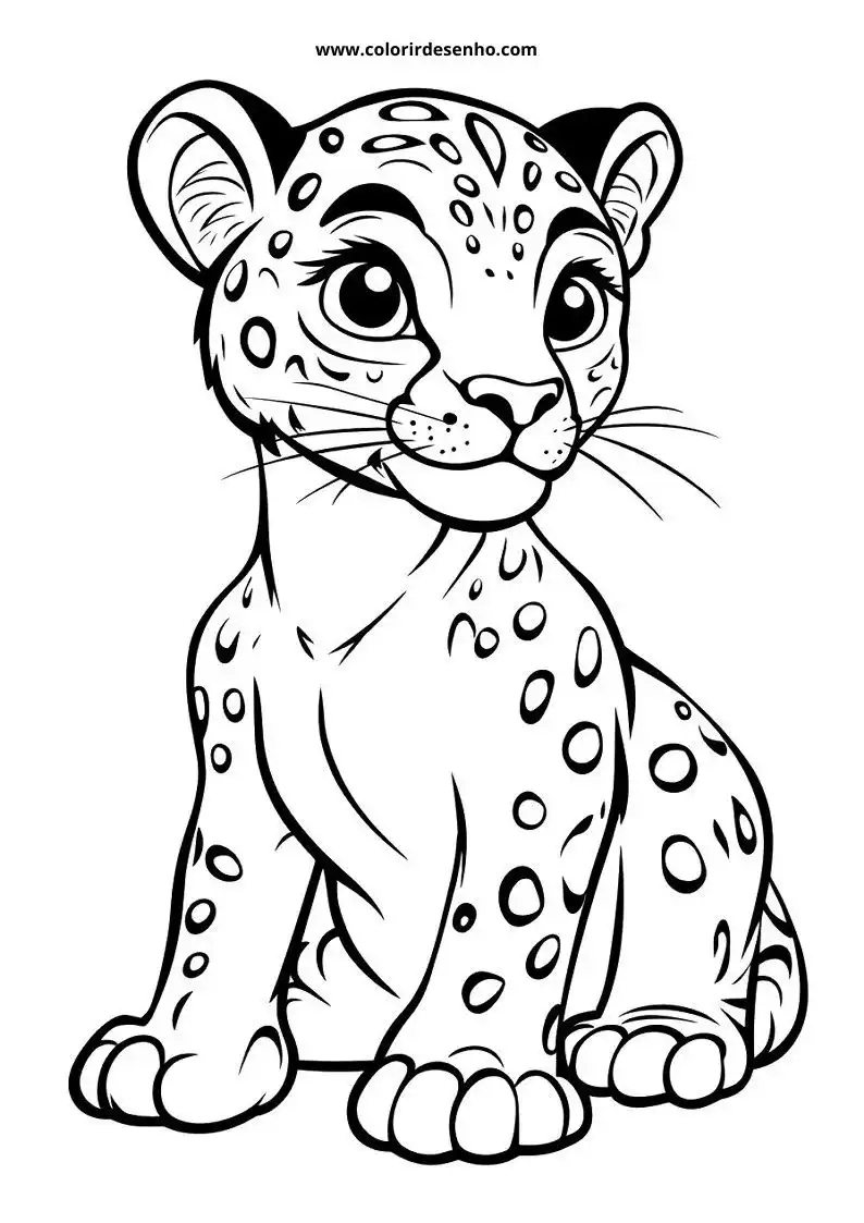 jaguar cub standing alertly with big eyes and spots on body